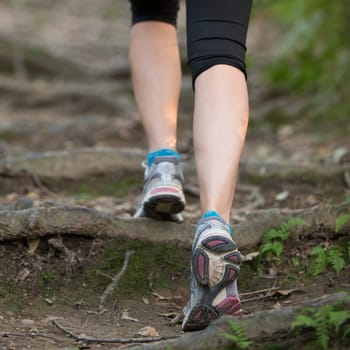 Woman jogging during outdoor workout in nature. Weight Loss. Healthy lifestyle consept.