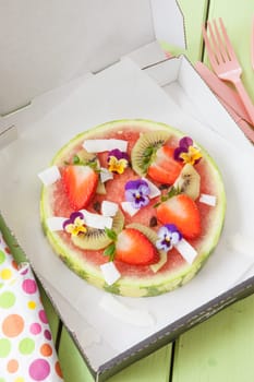 Fruit pizza from watermelon with fresh fruit with blueten