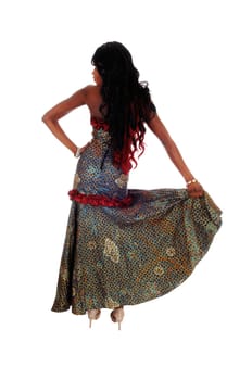 A beautiful African American woman standing in an African long dress.and black hair from the back, isolated for white background..