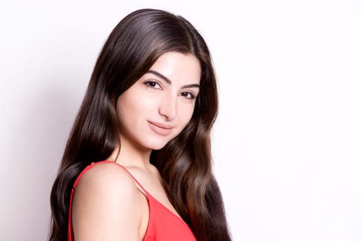 pretty brunette with long hair on white background wearing red
