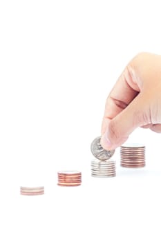 Woman hand putting money coin for saving money concept