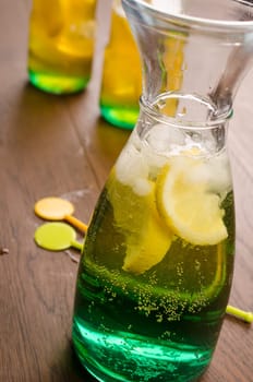 Rainbow colored cocktail on a wooden table