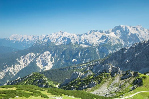 Alps mountains summer aerial view with free soaring paraglider over beautiful Alpine landscape