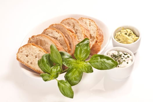 Fresh bread with herb butter and herb quark