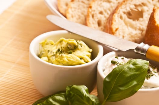 White bread prepared with herb butter and herb quark