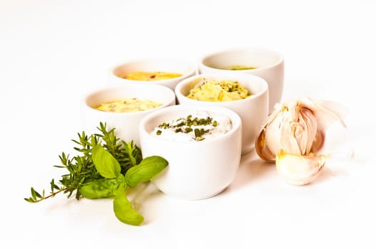 Herbal butter and herb quark in white bowls