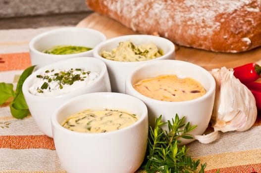 Herbal butter and herb quark in white bowls