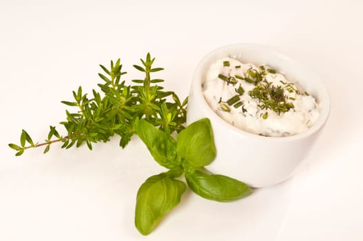 Herbal butter and herb quark in white bowls