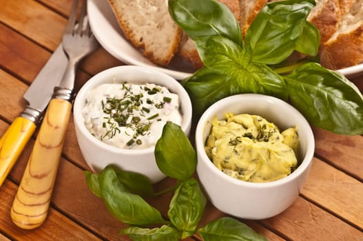 Herbal butter and herb quark in white bowls