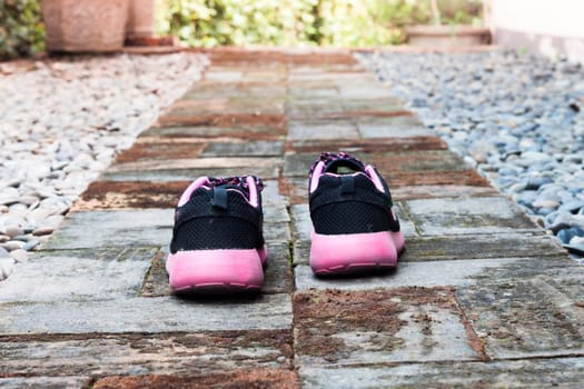 Running shoes in home garden foot path, stock photo