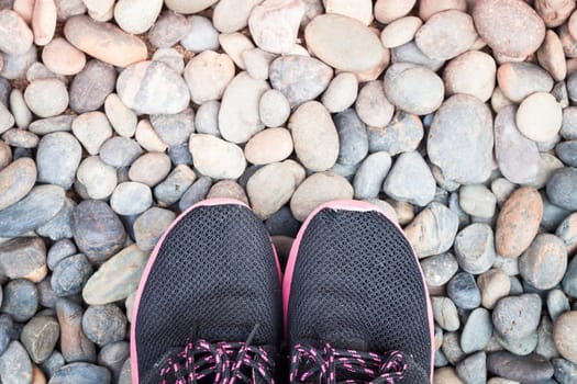 Running shoes in home garden on pebbles, stock photo