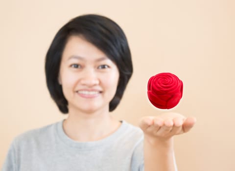 Red rose of ring box on woman hand, stock photo