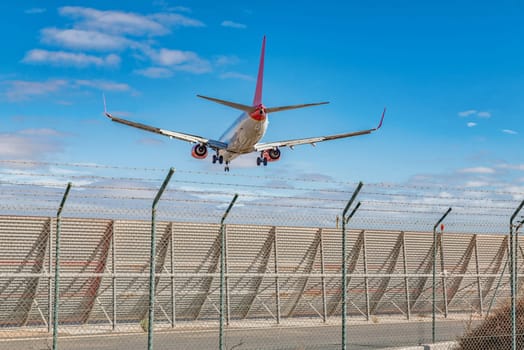 a plane flies over the border fence