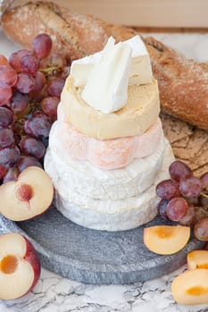 Stacks of different soft caess with fresh fruit