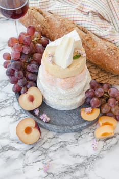 Stacks of different soft caess with fresh fruit
