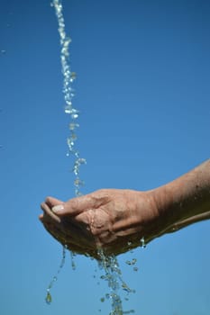 water flowing from the sky into open cupped hands