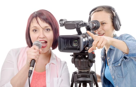 a young woman journalist with a microphone and camerawoman