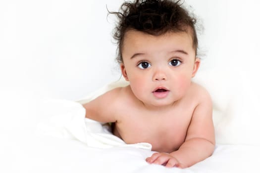 adorable baby boy wrapped with blanked on white background