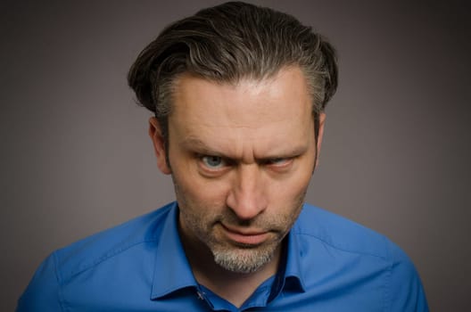 Business man looking crazy on a studio background