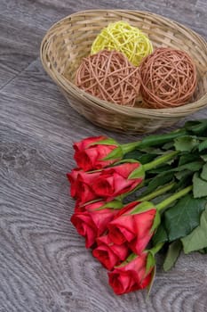 Red roses on a grey wooden background