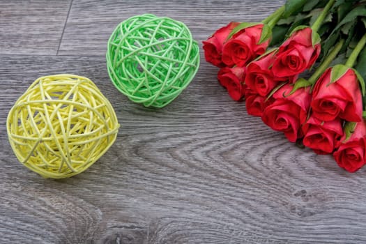 Red roses on a grey wooden background