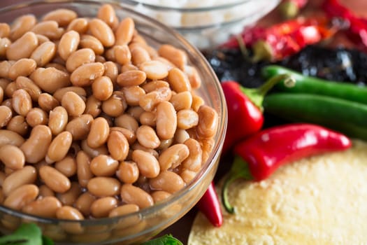 Cooked pinto beans and other ingredients for Mexican cooking.