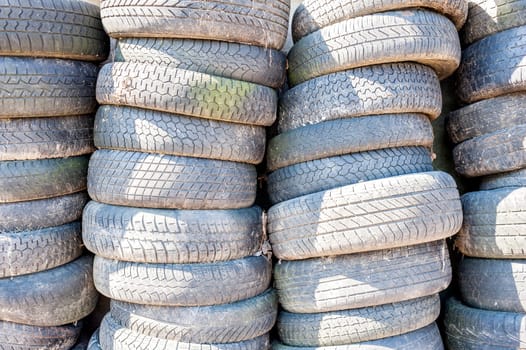 Old used tires stacked with high stacks