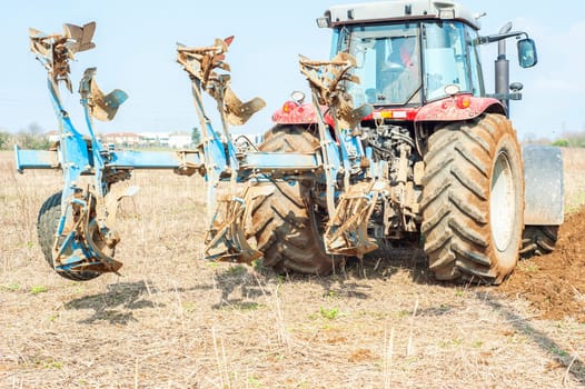 Agricultural work.  Tractor plowing the stubble field