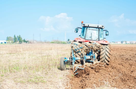 Agricultural work.  Tractor plowing the stubble field