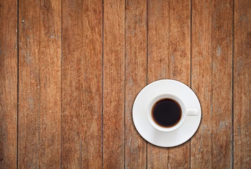 Top view of white coffee cup on wooden background, stock photo