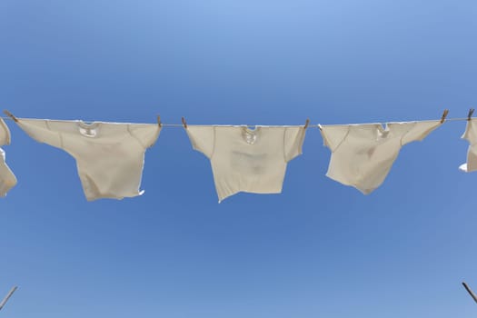 White t-shirts hanging to dry on a clothesline