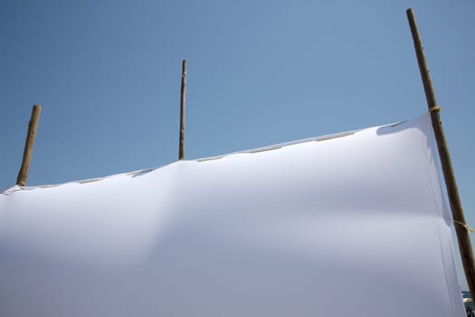 blank white canvas against blue sky