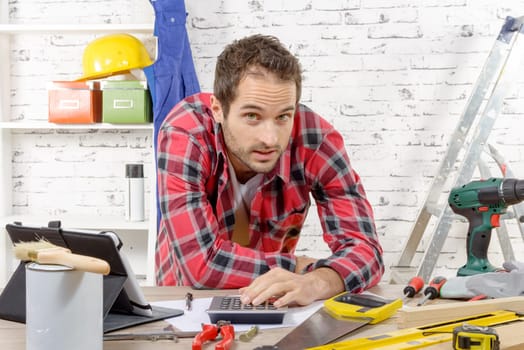 a smiling young carpenter in his workshop