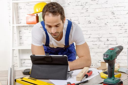 attractive young man using the tablet for DIY