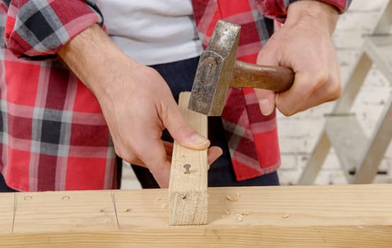 a carpenter hammer a nail