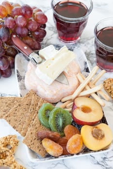 Rustic kaese platte with fruits and crisps