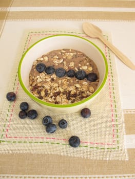 Smoothie Bowl for spooning with muesli,blueberries and cocoa nibs