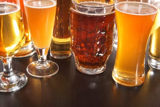 Many different beer glasses with different beer from all over the world