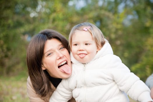 mother and little daughter doing grimaces for fun
