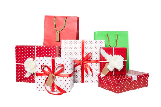 Stack of Christmas gifts and giftbags isolated on white background