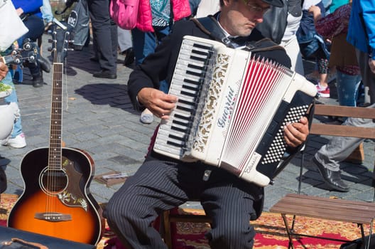 street artist playing his guerrini accordeon in the streets of zutphen, netherlands