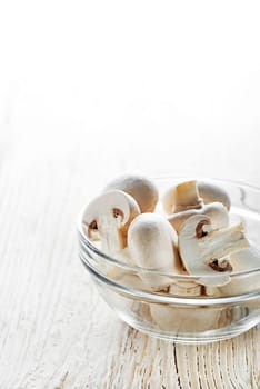 Fresh mushrooms champignons on a wooden background.