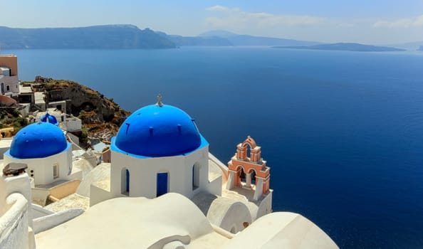Church domes in Oia by beautiful day, Santorini, Greece
