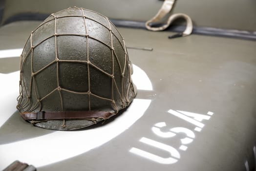 military helmet on the hood of military vehicle with with star