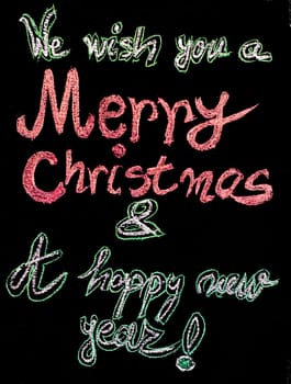 We wish you a Merry Christmas and a happy new year, hand writing with chalk on blackboard, vintage concept