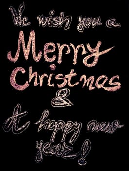 We wish you a Merry Christmas and a happy new year, hand writing with chalk on blackboard, vintage concept