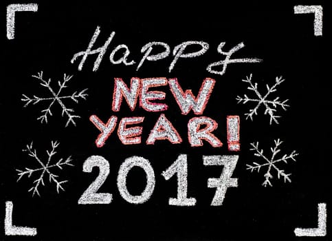 Happy new year 2017, hand writing with chalk on blackboard, vintage concept