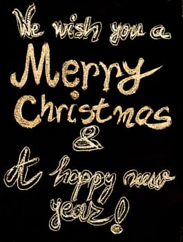 We wish you a Merry Christmas and a happy new year, hand writing with chalk on blackboard, vintage concept