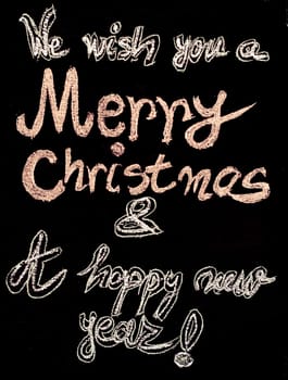 We wish you a Merry Christmas and a happy new year, hand writing with chalk on blackboard, vintage concept