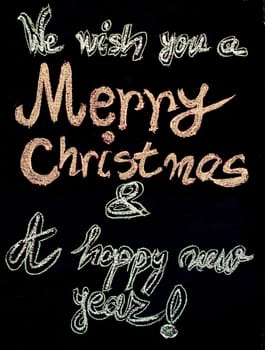 We wish you a Merry Christmas and a happy new year, hand writing with chalk on blackboard, vintage concept
